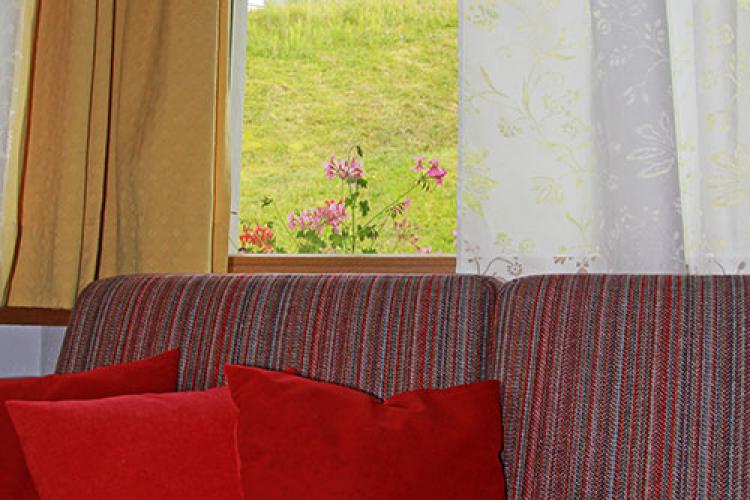 Ferienwohnung Prënsa – Sofa mit Blick zum Langkofel